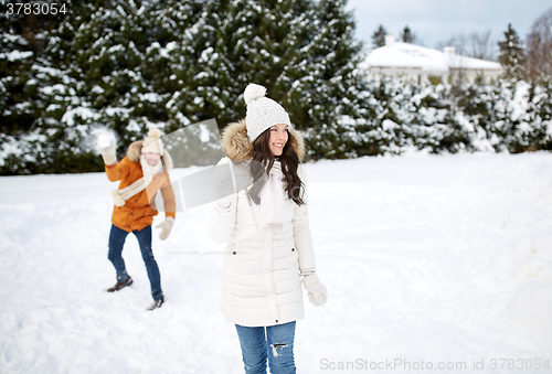 Image of happy couple playing snowballs in winter