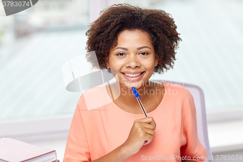 Image of happy african american woman with laptop at home