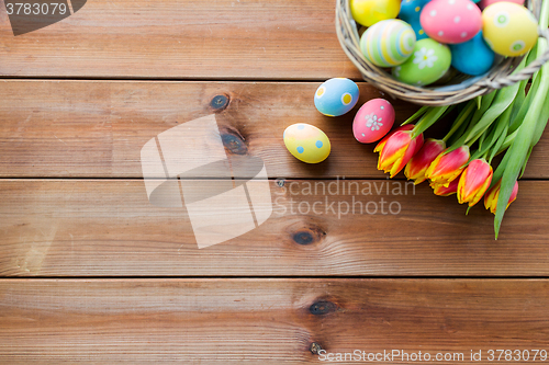 Image of close up of easter eggs in basket and flowers