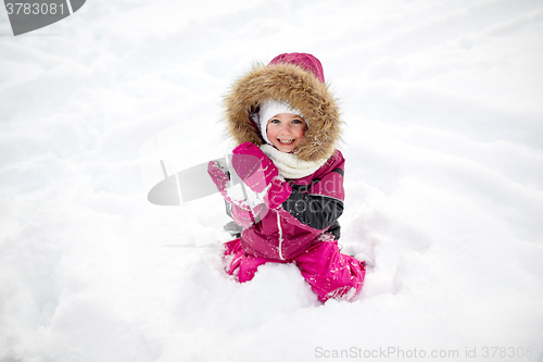 Image of f happy little child or girl with snow in winter