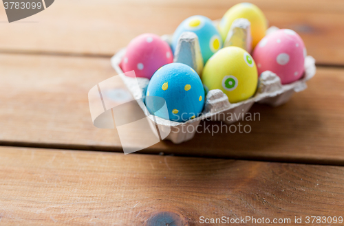 Image of close up of colored easter eggs in egg box