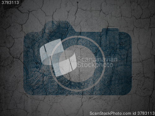 Image of Travel concept: Photo Camera on grunge wall background