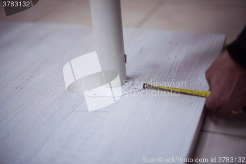 Image of carpenter worker measuring