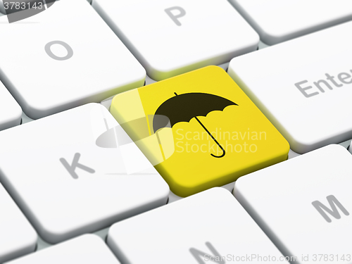 Image of Safety concept: Umbrella on computer keyboard background