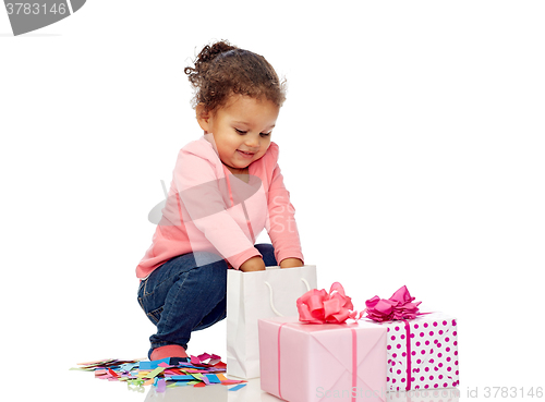 Image of happy little baby girl with birthday presents