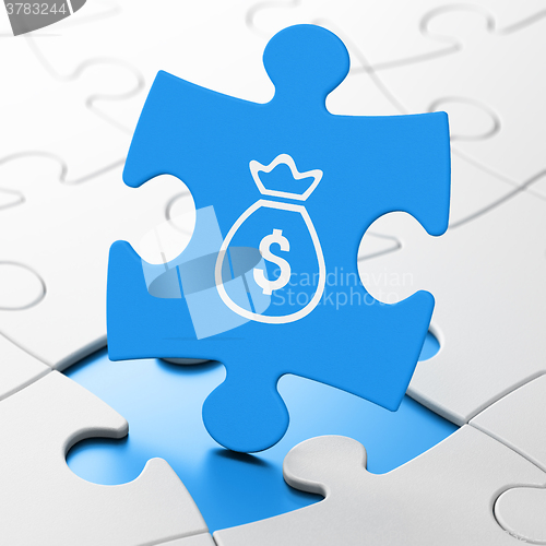 Image of Money concept: Money Bag on puzzle background