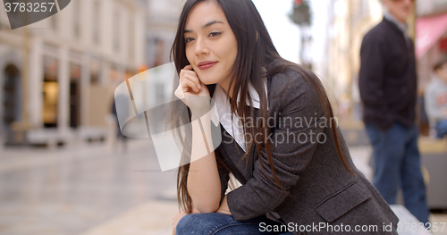 Image of Young woman sitting waiting for someone