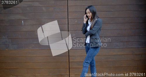 Image of Stylish trendy woman chatting on a mobile