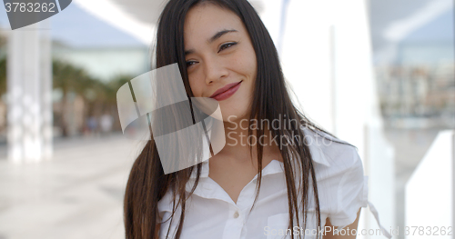 Image of Pretty young woman in a white summer top