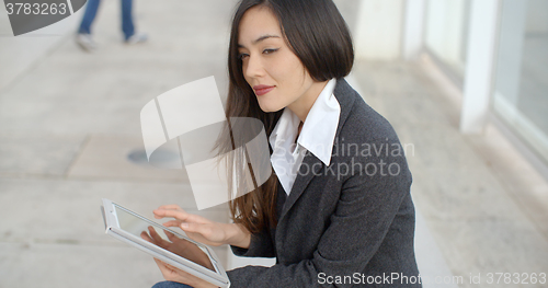 Image of Calm professional woman using tablet