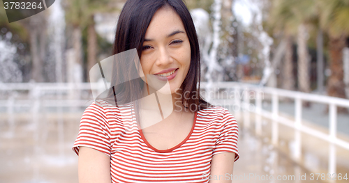 Image of Beautiful young woman in front of fountains