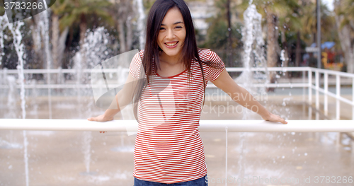 Image of Trendy young woman outdoors in summer