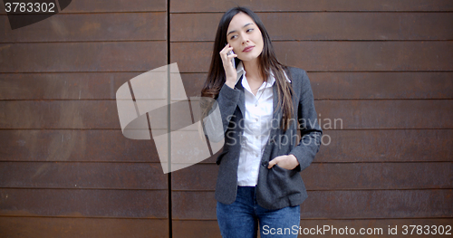 Image of Casual relaxed young woman talking on a mobile