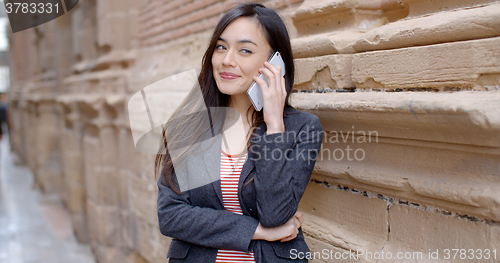Image of Young woman listening to a call on her mobile