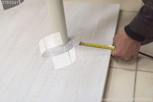 Image of carpenter worker measuring