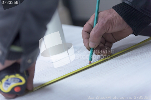 Image of carpenter worker measuring