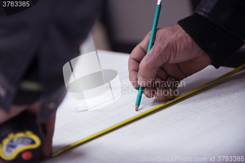 Image of carpenter worker measuring