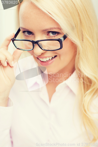 Image of smiling businesswoman or secretary in office