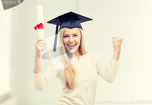 Image of student in graduation cap with certificate