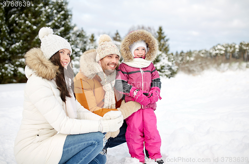 Image of happy family with child in winter clothes outdoors