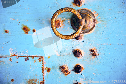 Image of rusty metal   nail dirty  and morocco knocker