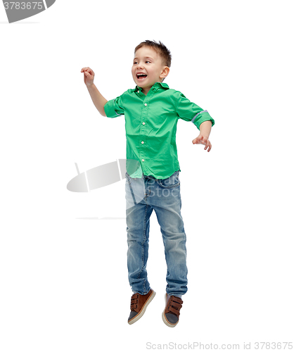 Image of happy little boy jumping in air