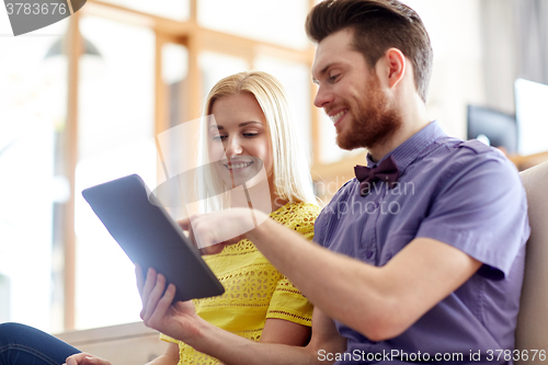 Image of happy creative team with tablet pc in office