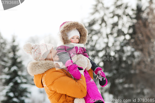 Image of happy family in winter clothes outdoors