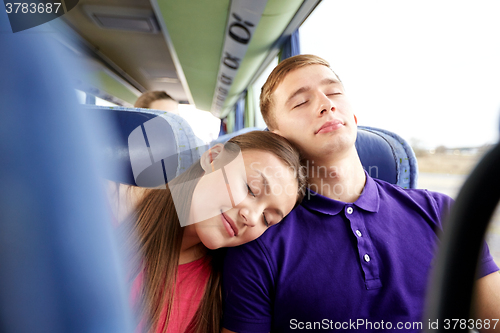 Image of happy couple or passengers sleeping in travel bus