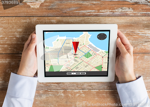 Image of close up of hands with navigator map on tablet pc