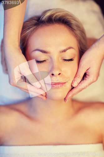 Image of close up of woman having face massage in spa