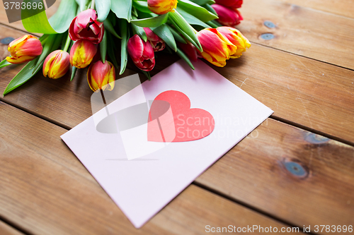 Image of close up of flowers and greeting card with heart