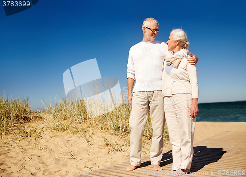 Image of happy senior couple talking outdoors