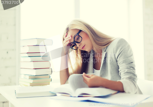 Image of student with books and notes