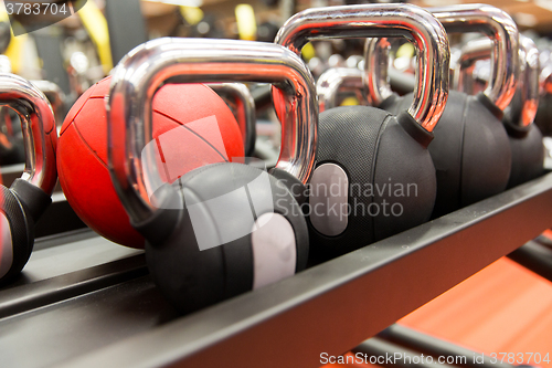 Image of close up of kettlebells and medicine ball in gym