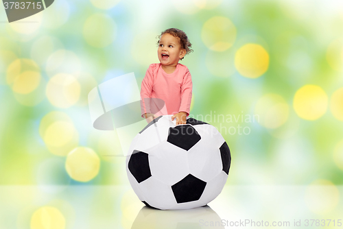 Image of happy mulatto little baby girl playing with ball