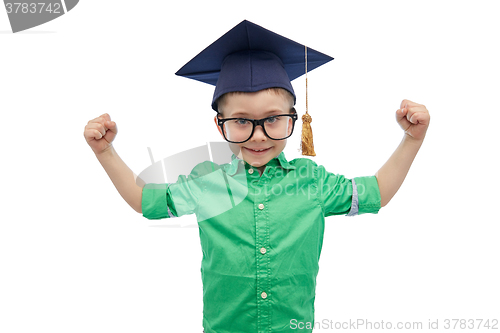 Image of happy boy in bachelor hat showing power