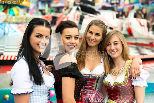 Image of Gorgeous young women at German funfair