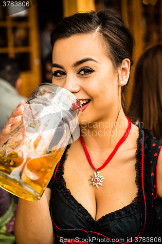 Image of Girl drinking beer at Oktoberfest