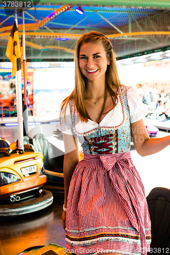 Image of Beautiful girl leaving an electric bumper car in amusement park