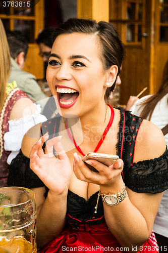 Image of Girl drinking beer at Oktoberfest