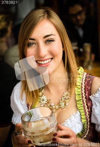 Image of Girl drinking beer at Oktoberfest