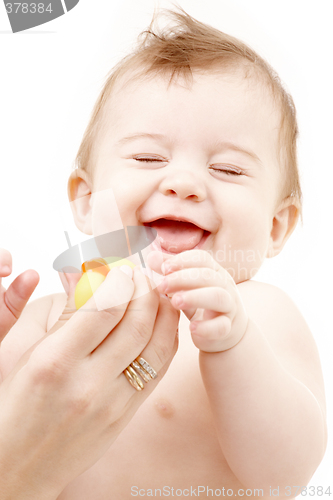 Image of laughing baby boy in mother hands with rubber duck