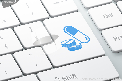 Image of Medicine concept: Pills on computer keyboard background