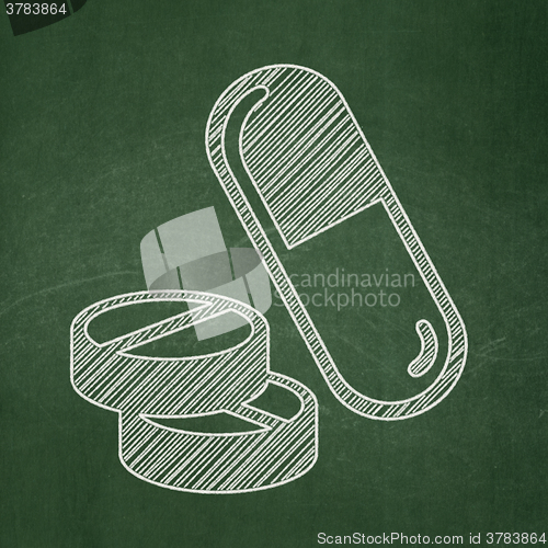 Image of Medicine concept: Pills on chalkboard background