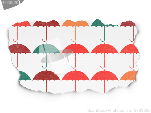 Image of Protection concept: Umbrella icons on Torn Paper background