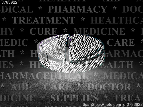 Image of Medicine concept: Pill in grunge dark room