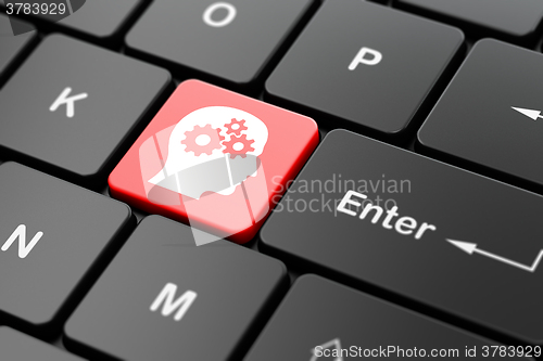 Image of Studying concept: Head With Gears on computer keyboard background
