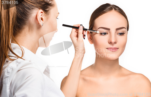 Image of Beautiful female eyes with make-up and brush