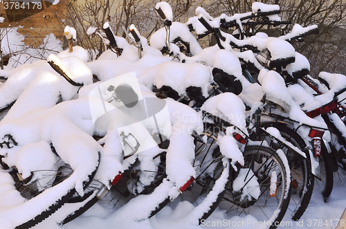 Image of bikes covered with a blanket of snow, winter in Finland